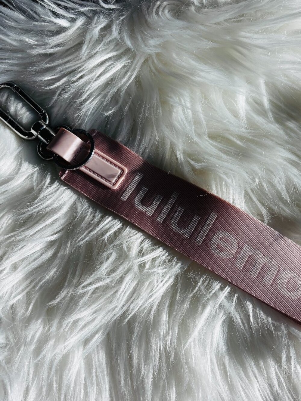 Wristlet o keychain by Lululemon in a pink color.